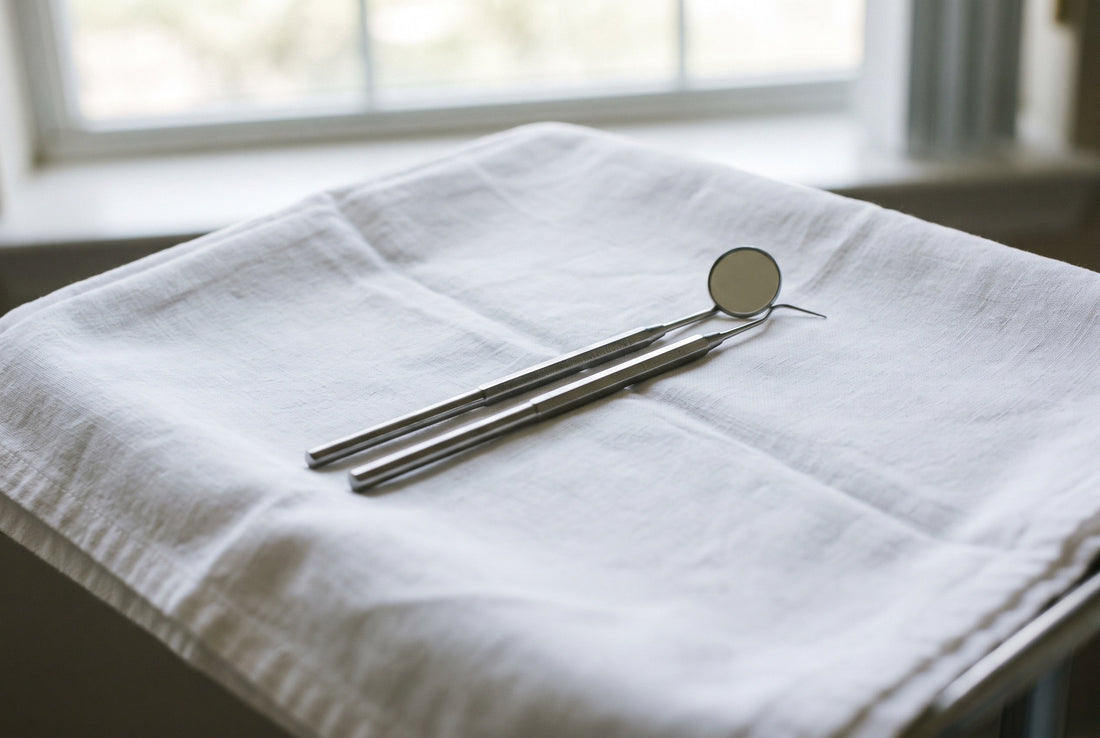 Dental mirror and probe on a clean white tray in daylight